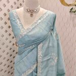 Semi Tussar Saree with floral embroidery, zari-patterned body, and minimal floral vine border