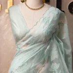 Net kota with fine grid checks, floral vine embroidery, and scalloped embroidered border