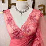 Net saree with delicate hand embroidery, with  a mix of cut beads and materials.