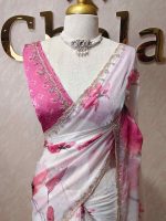 Georgette saree with scattered floral motifs on body decorated with sticky stones and scalloped boarder