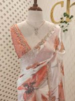 Georgette saree with scattered floral motifs on body decorated with sticky stones and scalloped boarder - Image 10
