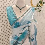 Georgette with large floral motifs on the pallu and body with beads and sequins