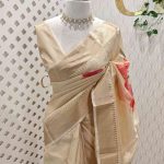Kerala saree with large contrast multi coloured flowers and leaf prints on the body and pallu
